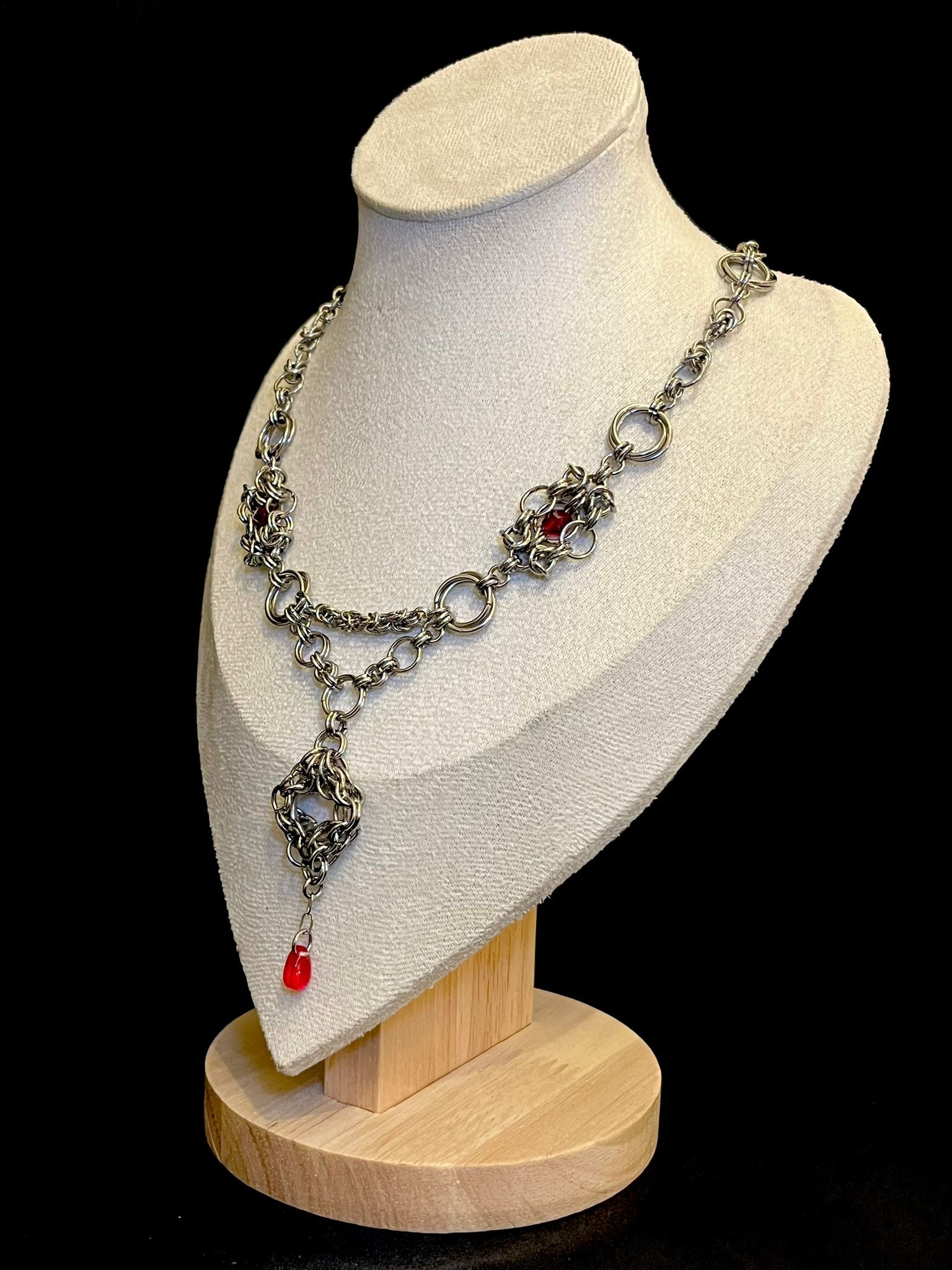 Necklace on a mannequin bust with a black background