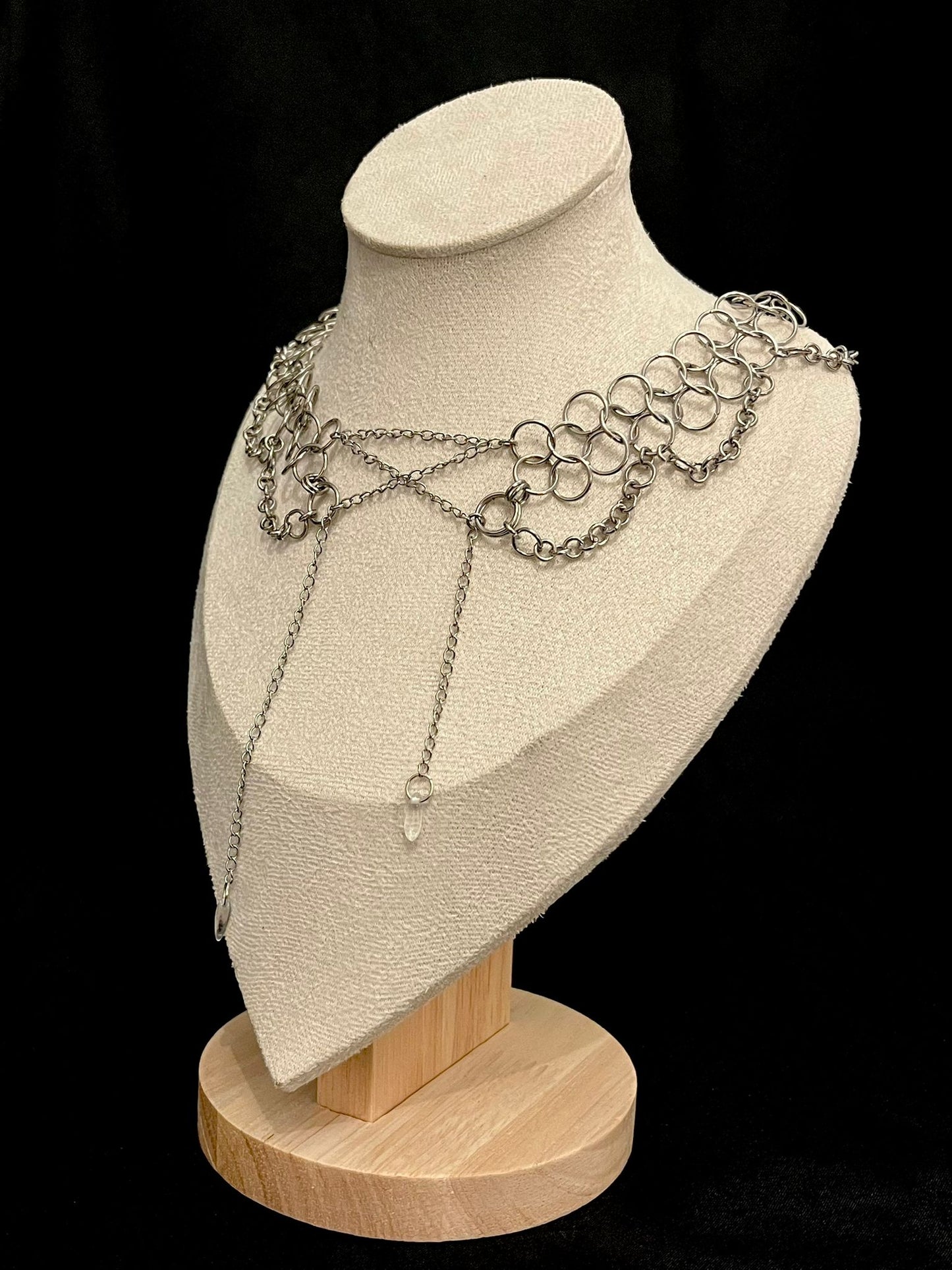 Necklace displayed on a mannequin bust with a black background