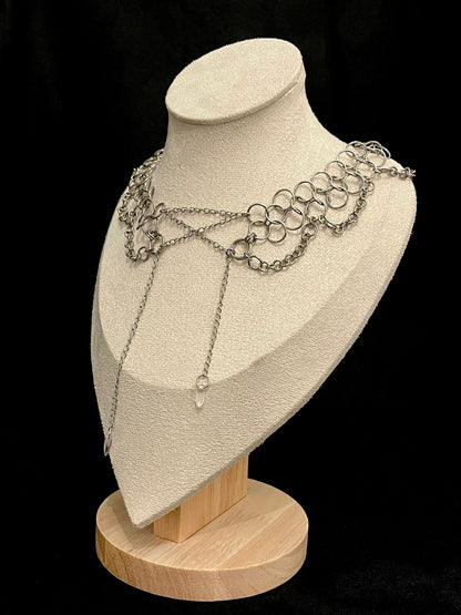 Necklace displayed on a mannequin bust with a black background