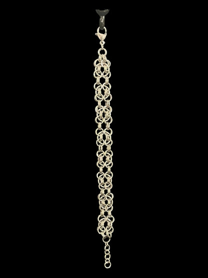 Silver bracelet hangiing from a hook