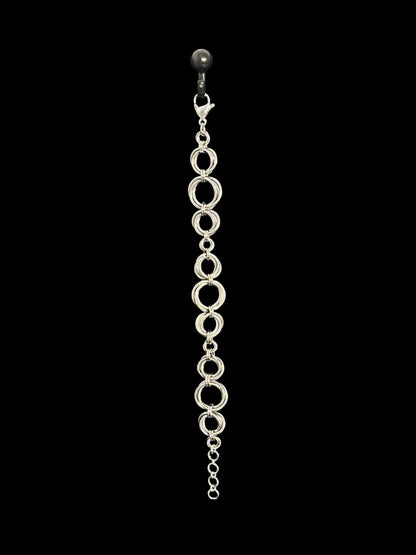Silver chain earring on a black background