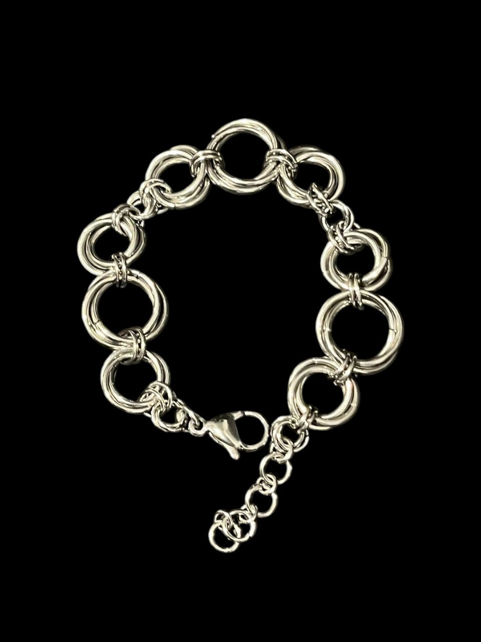 Silver chain bracelet on a black background