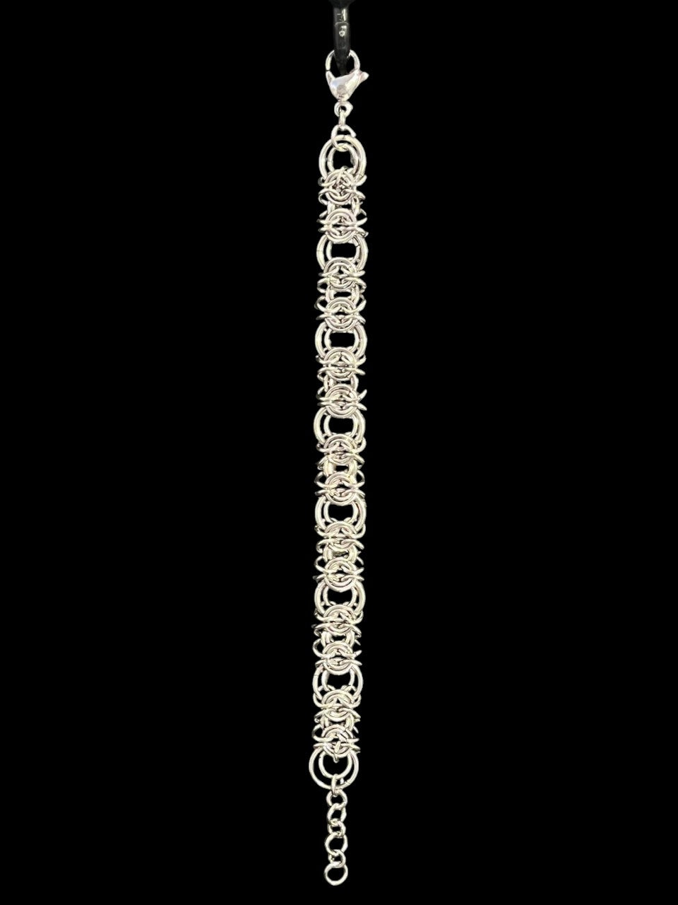 Silver chain bracelet on a black background