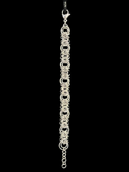 Silver chain bracelet on a black background