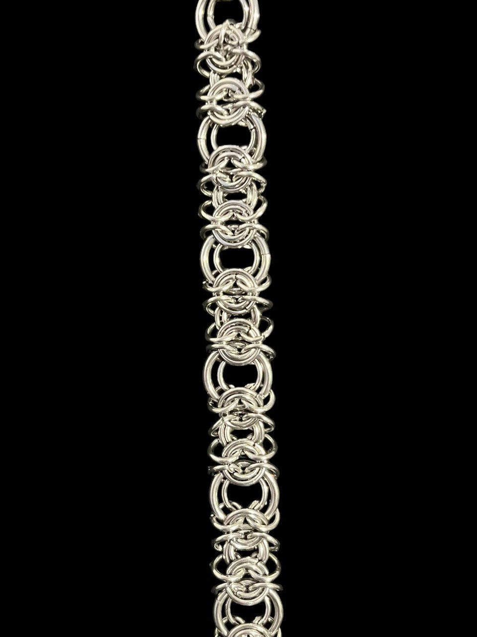Silver chainmaille bracelet on a black background