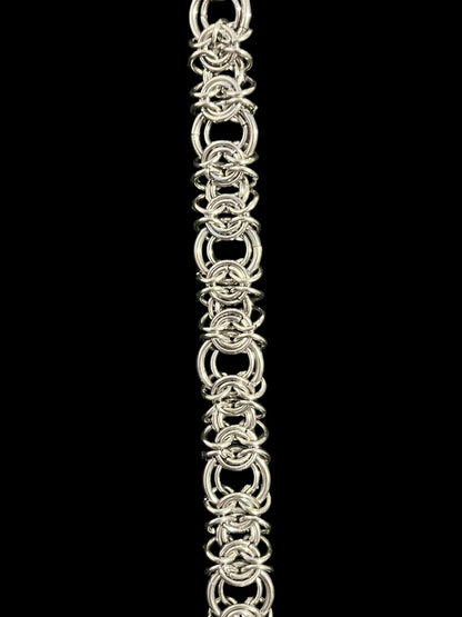 Silver chainmaille bracelet on a black background